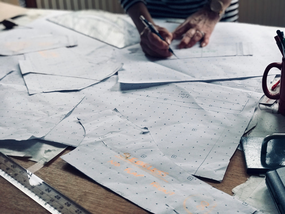 Our pattern-cutter creating the patterns by hand for our Careaux dress 