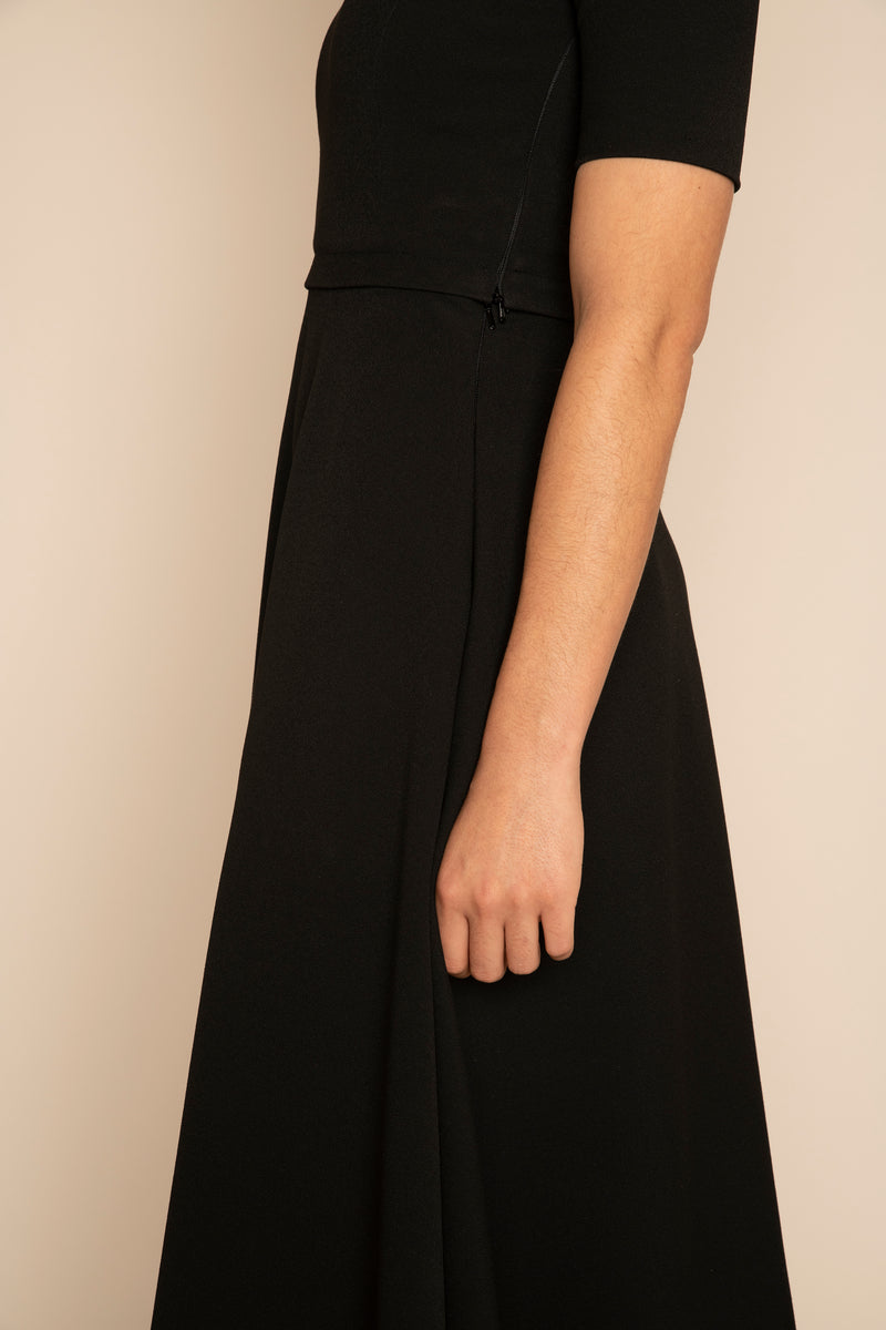 Close up of the side of the Black Sleeved Catherine Top with the Black Midi Elizabeth Skirt with our signature Careaux zip around the waist.