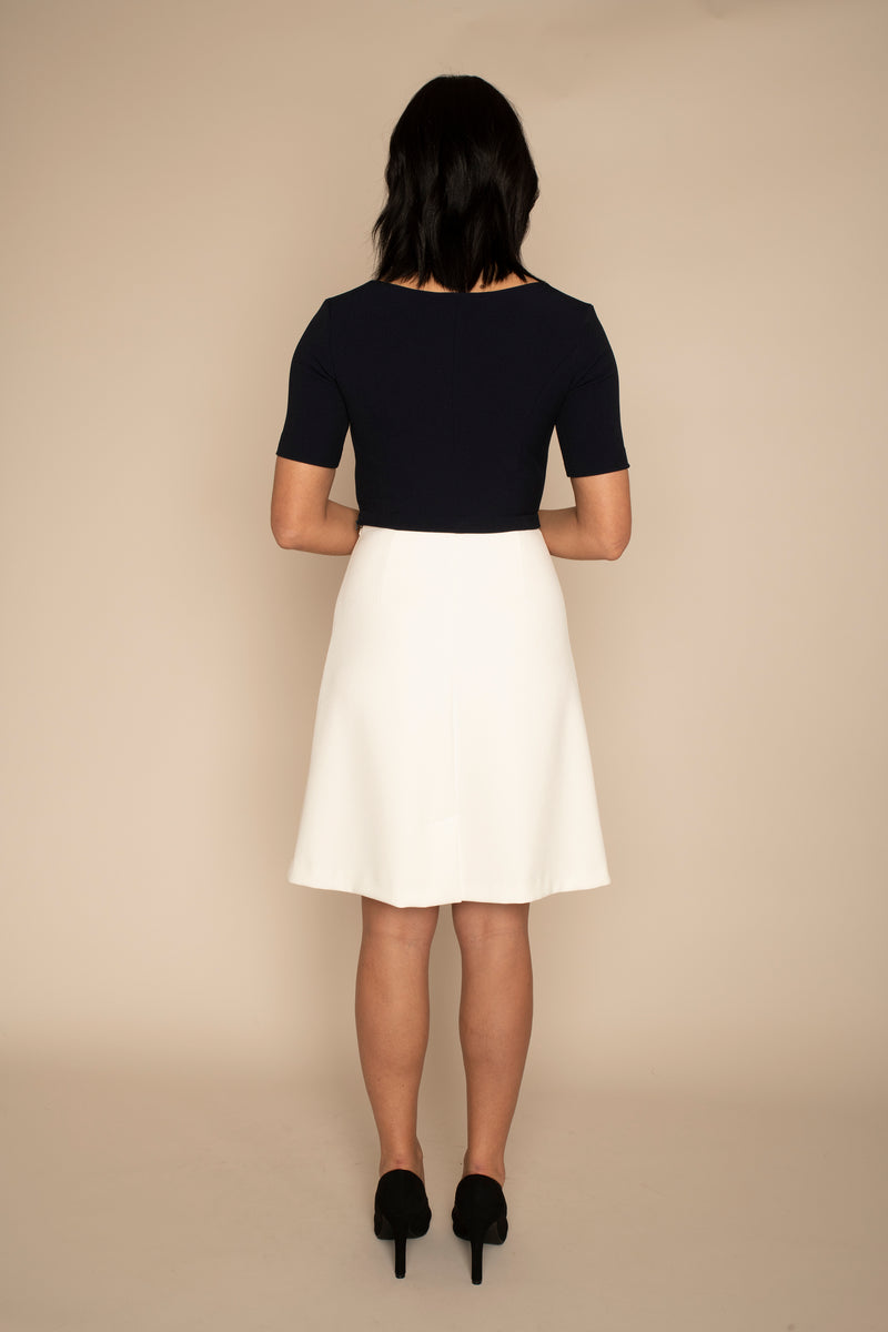 Back view of the Navy Sleeved Catherine top and the ivory a-line VICTORIA skirt with our signature Careaux zip around the waist.