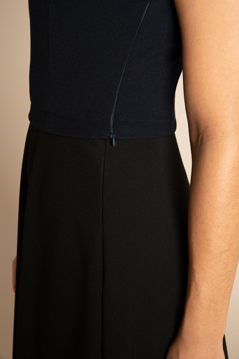 Side view of the navy sleeveless eleanor top and the black midi elizabeth skirt with our signature Careaux zip around the waist.
