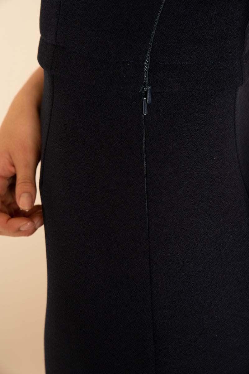 Close up of the side of the Navy Sleeved Catherine Top and the Navy A-Line Victoria Skirt with our signature Careaux zip around the waist and hidden side zips.