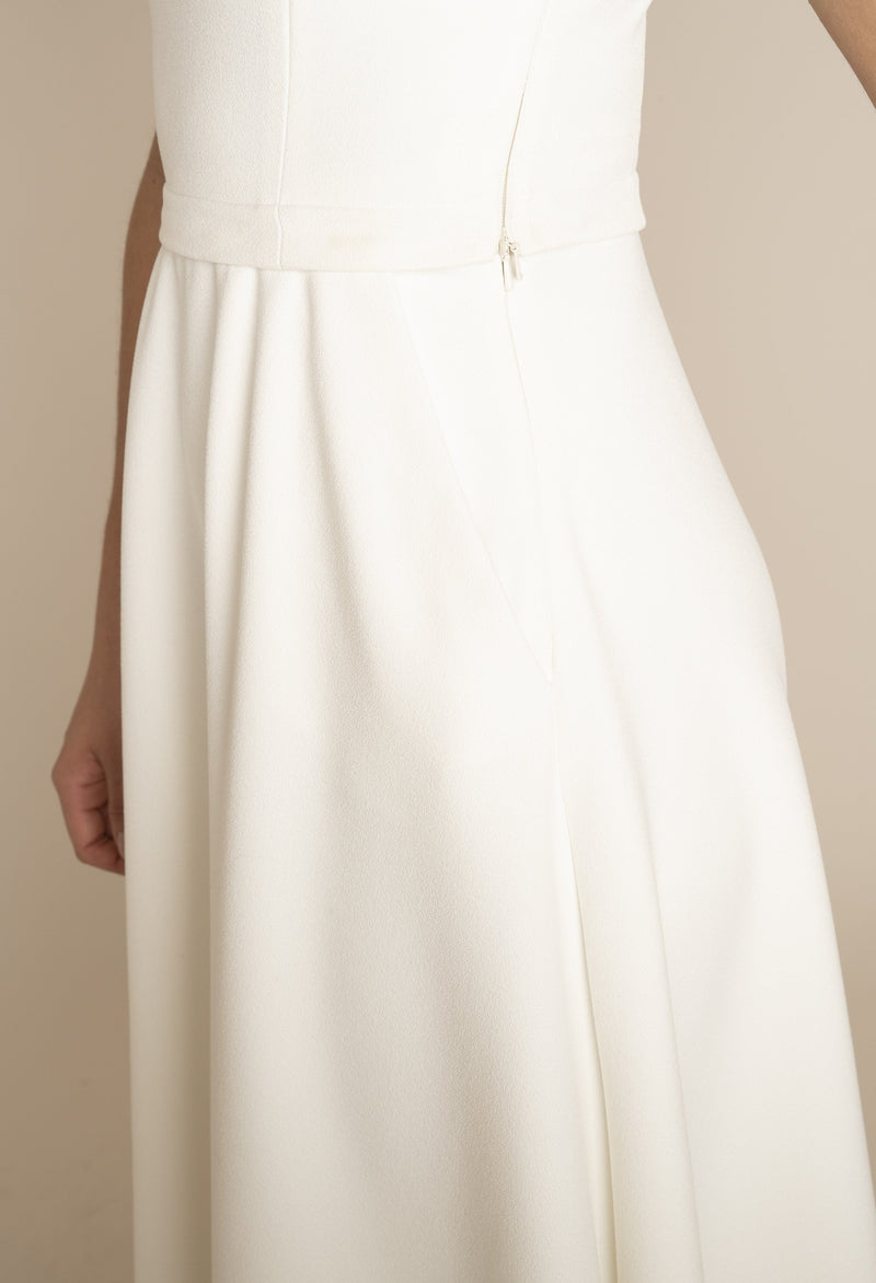 Close up of the side of Ivory Sleeveless Eleanor Top with the Ivory Midi Elizabeth Skirt with pockets with our signature Careaux zip around the waist.